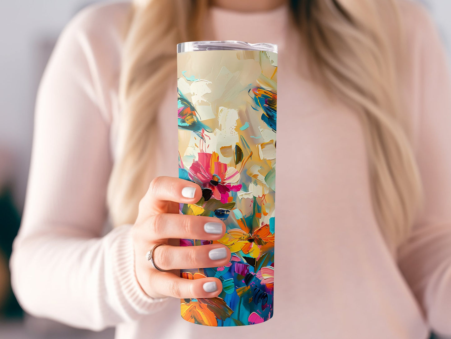 Model holding abstract butterfly tumbler with metal straw and slim, straight skinny design for on-the-go use