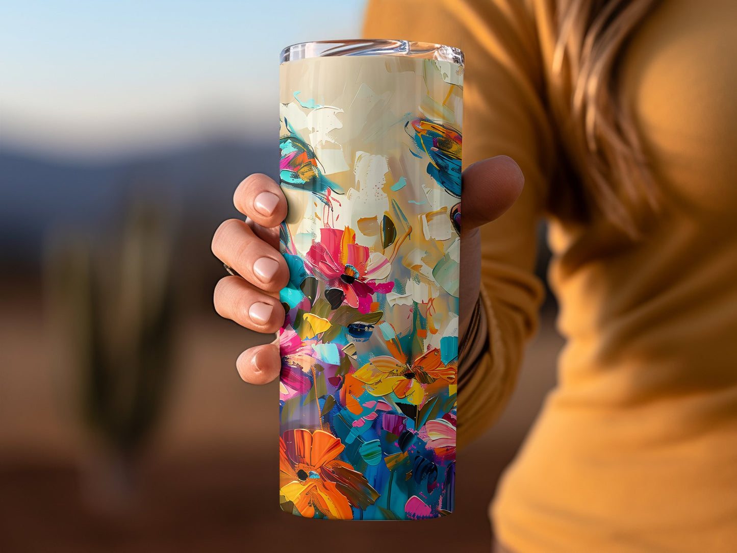 Woman holding insulated butterfly tumbler, 20oz stainless steel with vivid abstract artwork and secure lid