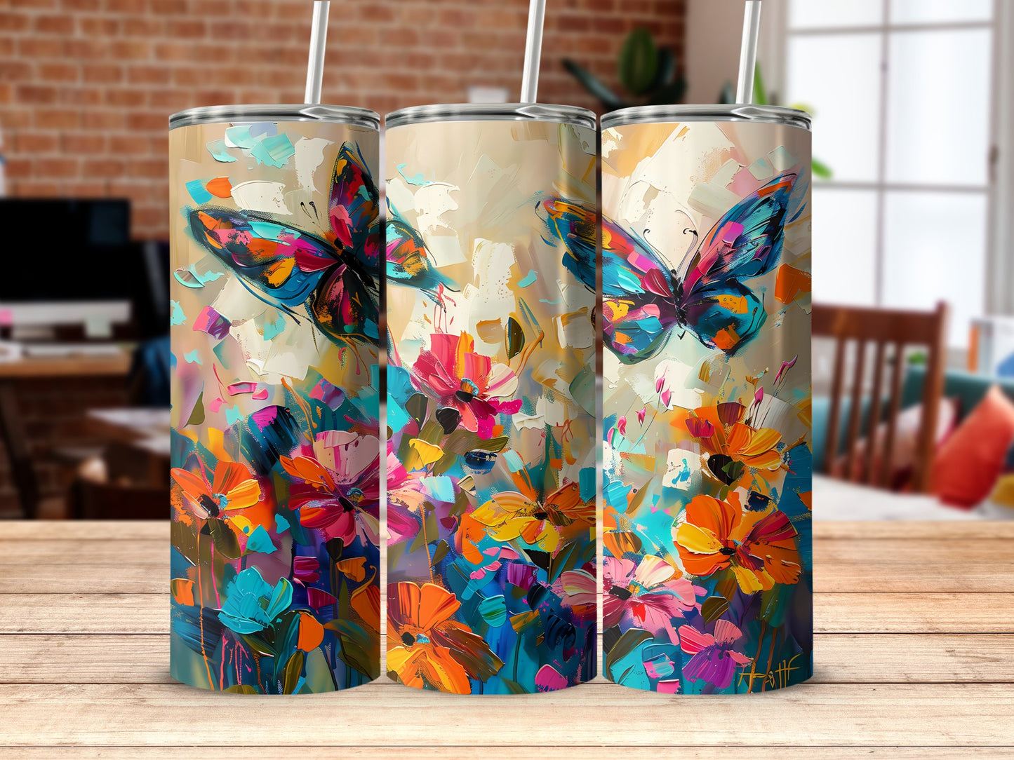 Abstract butterfly tumbler resting on table, 20oz insulated stainless steel with sleek design and metal straw