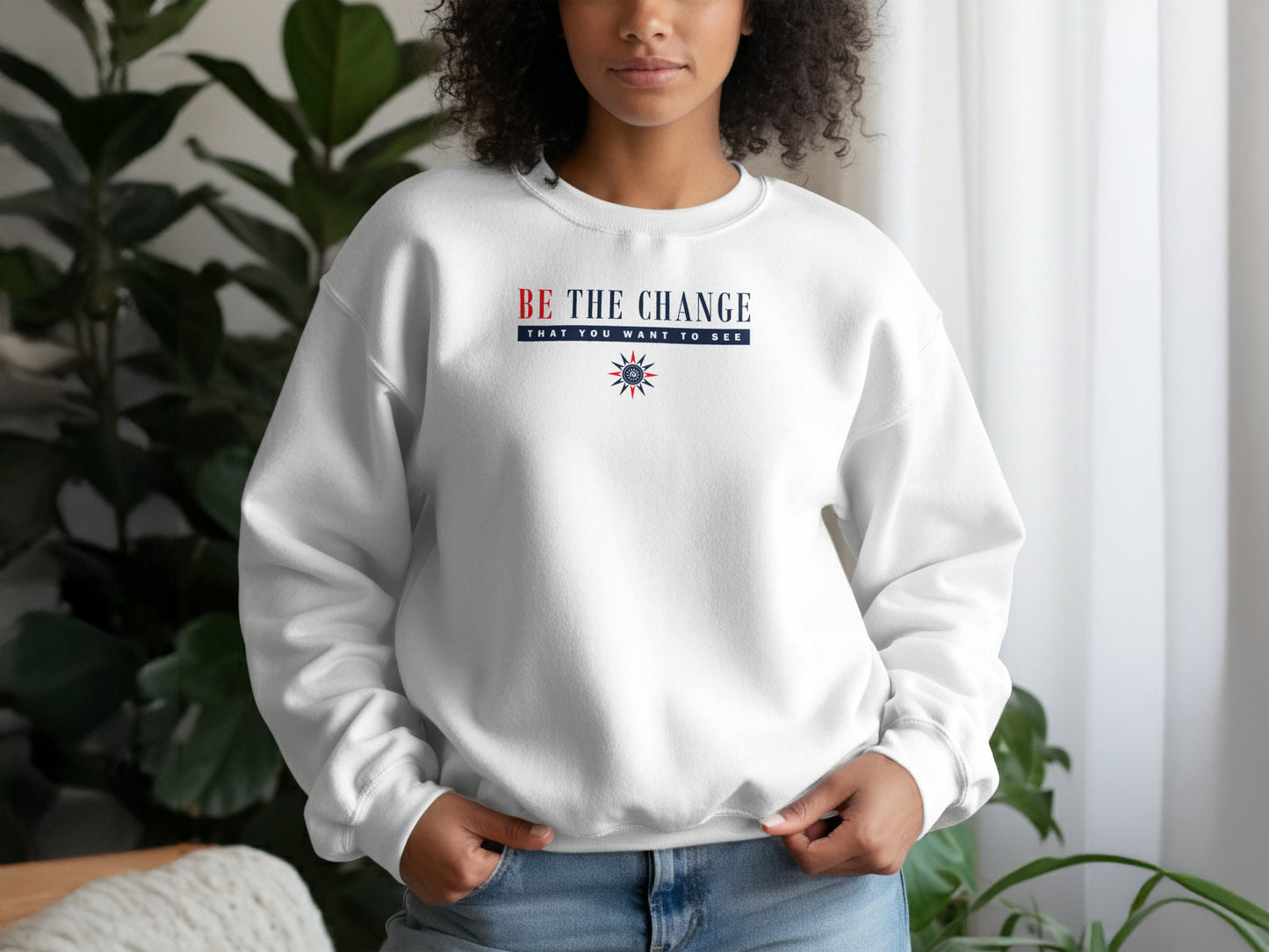 White Be the Change graphic sweatshirt with motivational quote, long sleeves, and relaxed cotton blend unisex fit.