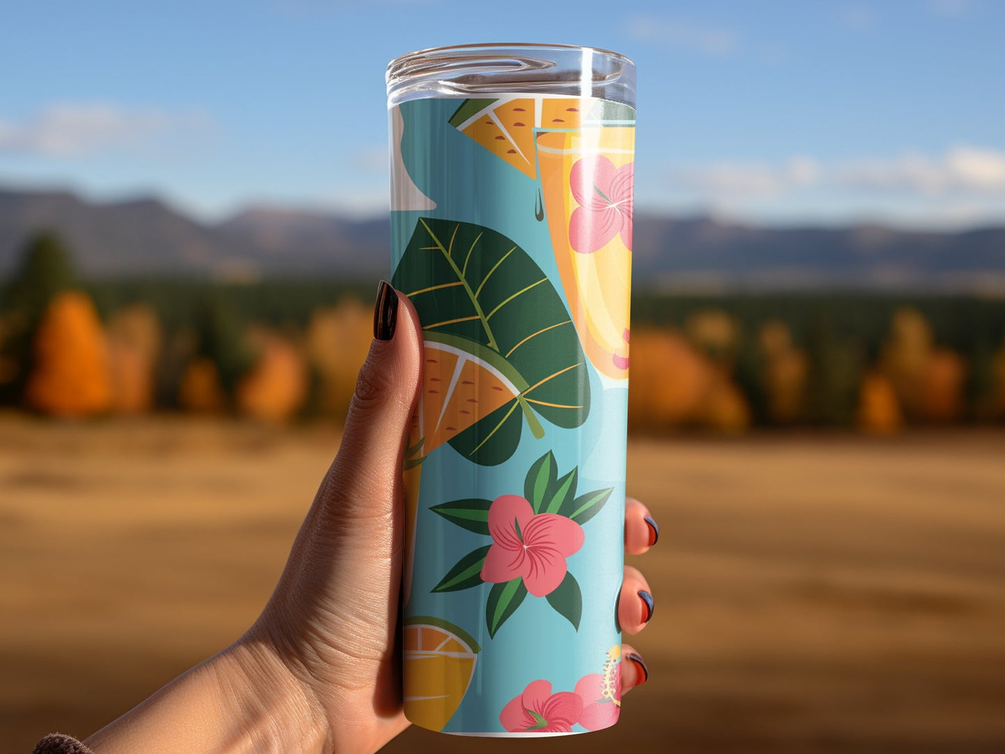 Double-wall travel tumbler featuring poolside cocktail illustrations with pineapple, cherries, and bright tropical colours.