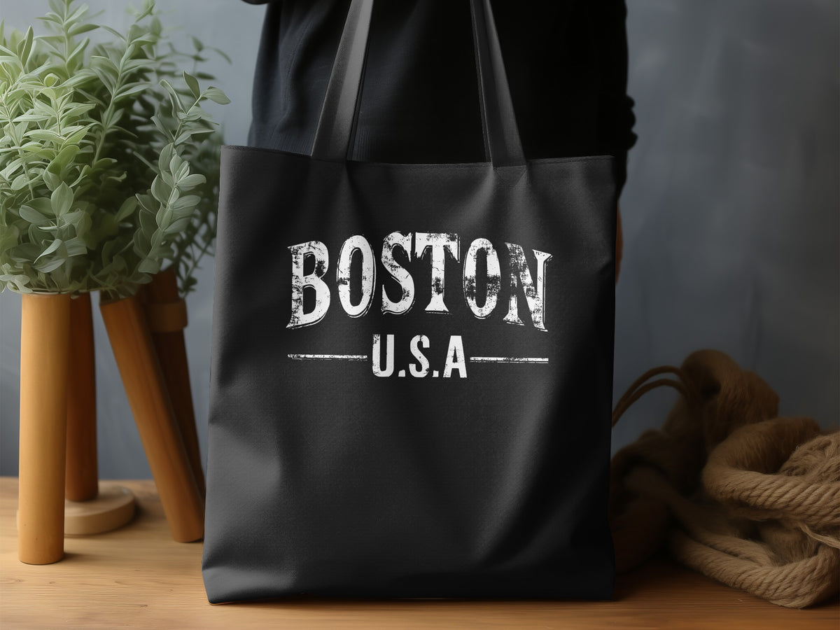 Boston Tote Bag displaying the full BOSTON U.S.A design with spaced serif lettering, horizontal rules and distressed white print on black canvas.