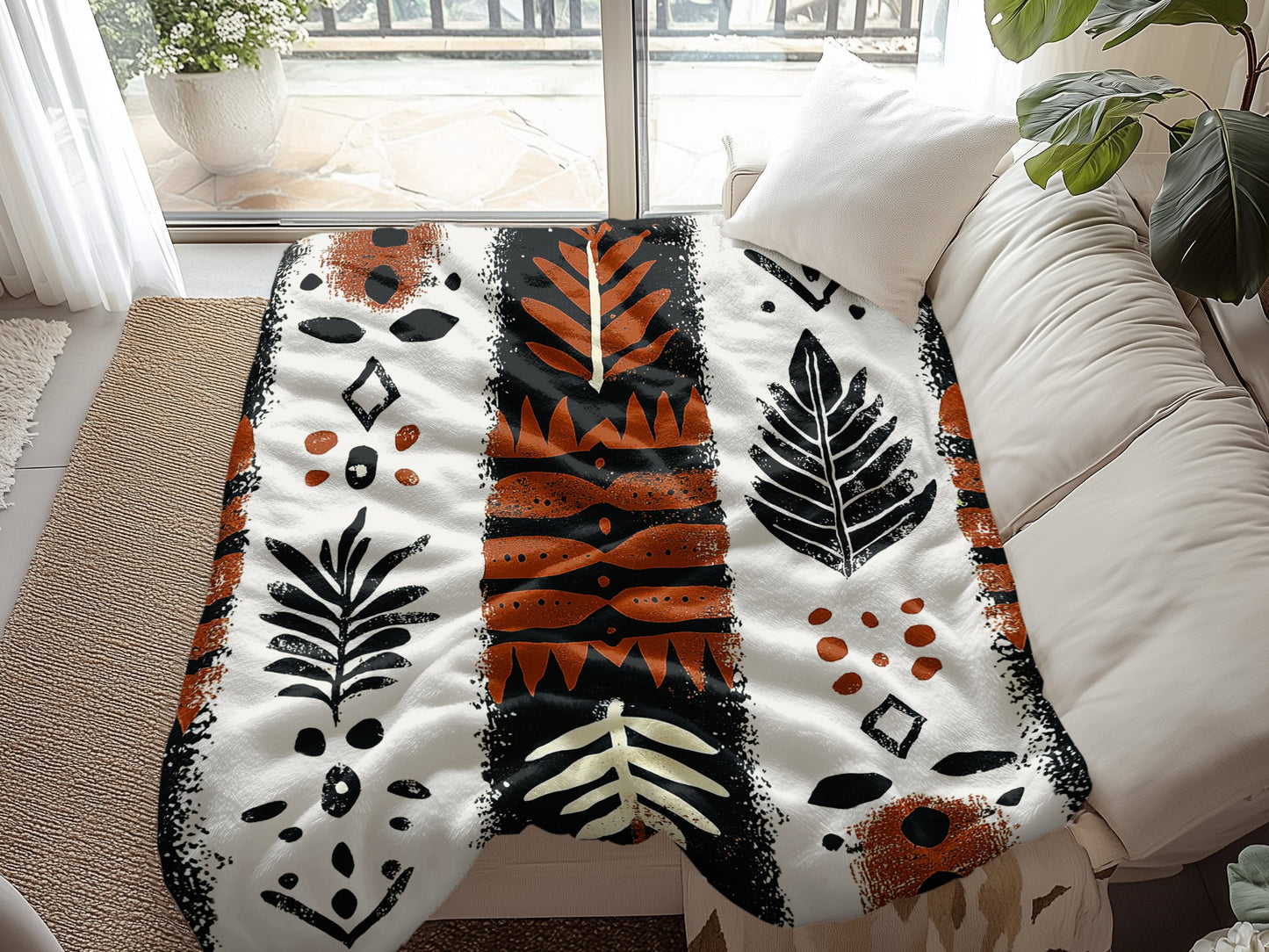 Earth Rituals Arctic Fleece Blanket spread across a couch, offering warmth and natural, earthy design to your room.