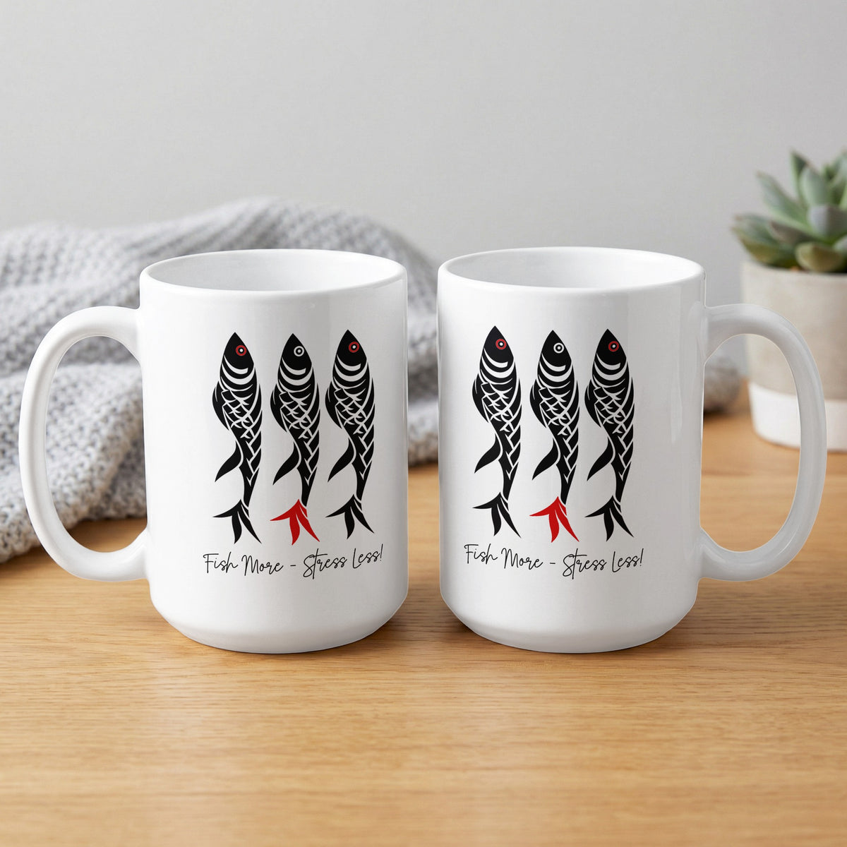 White ceramic Fish More Stress Less Mug showing front and back, with three patterned fish, red accents and black script lettering.