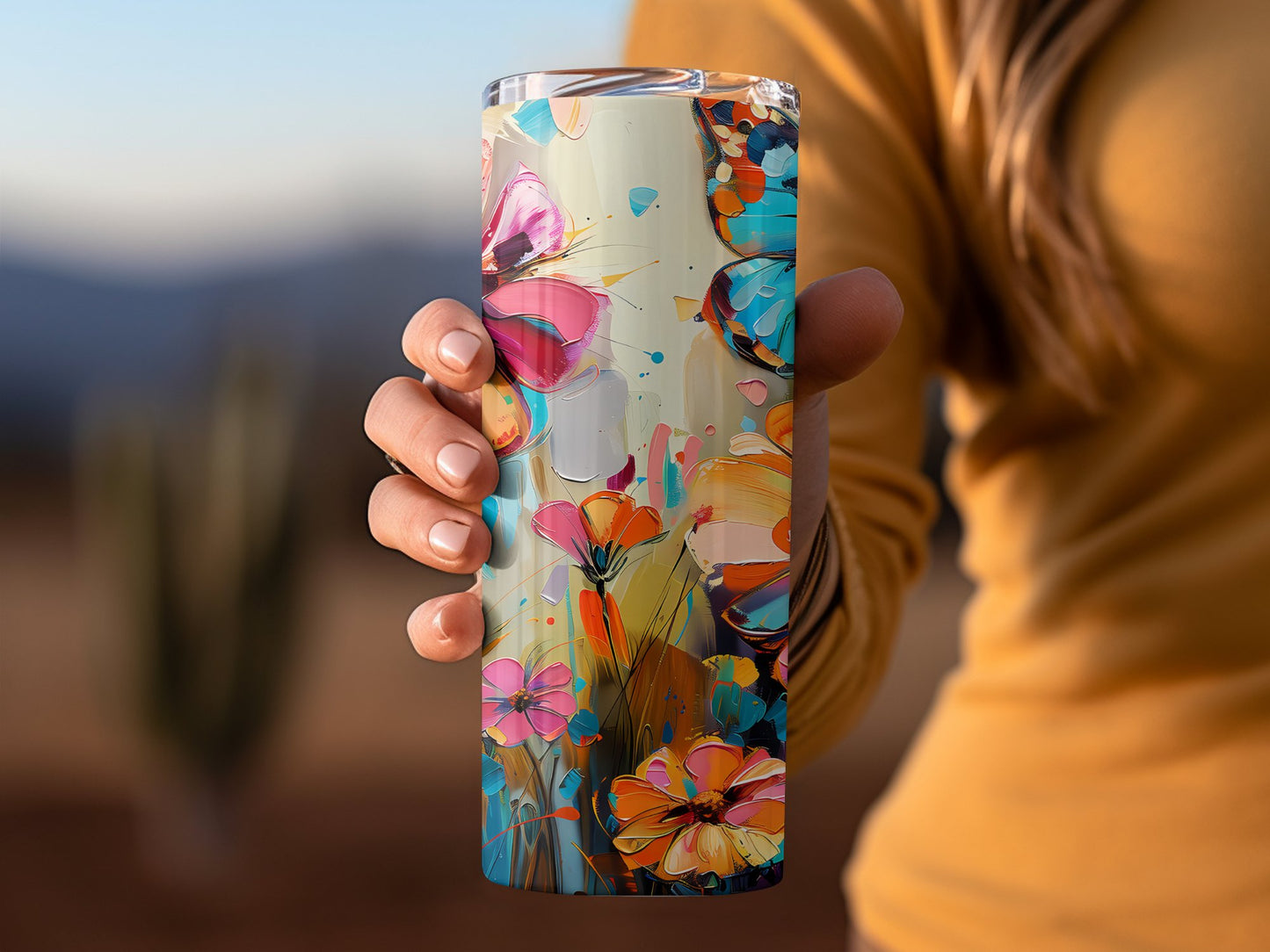Floral butterfly tumbler in hand, 20oz stainless steel with delicate butterfly artwork and secure clear lid