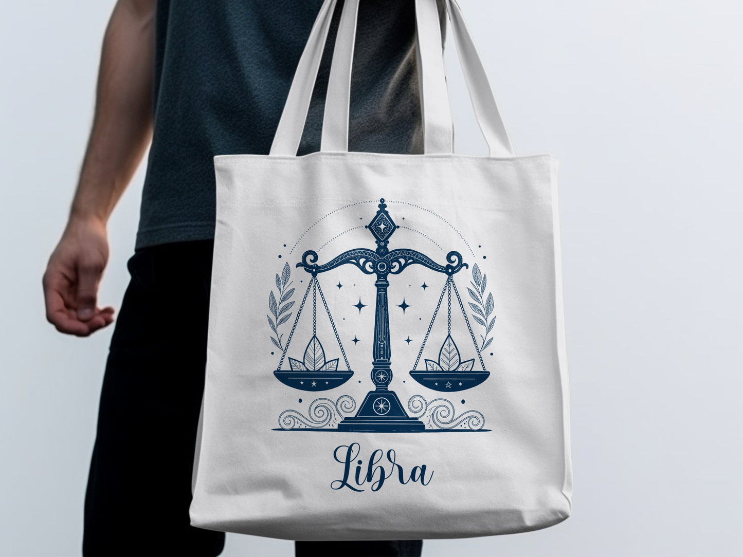 Libra tote bag with elegant zodiac scales illustration, flowing symmetry, and delicate leaf sprig detailing throughout.