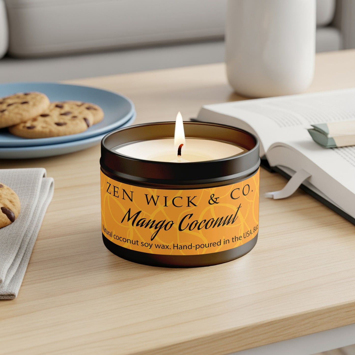 Mango Coconut coconut soy candle 8oz in reusable black tin with amber-gold citrus label and branding.