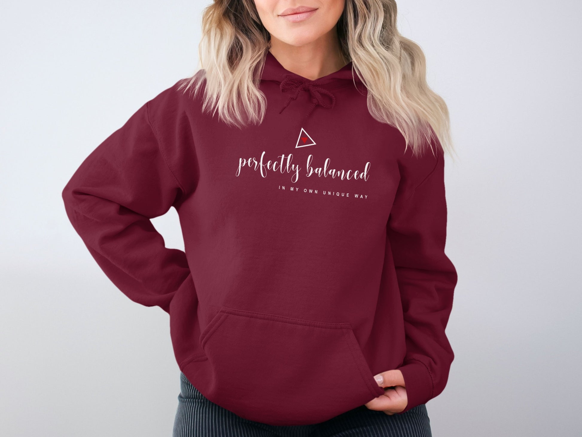 Maroon unisex hoodie with Perfectly Balanced graphic, cozy fleece interior, motivational print, and durable seamless structure.