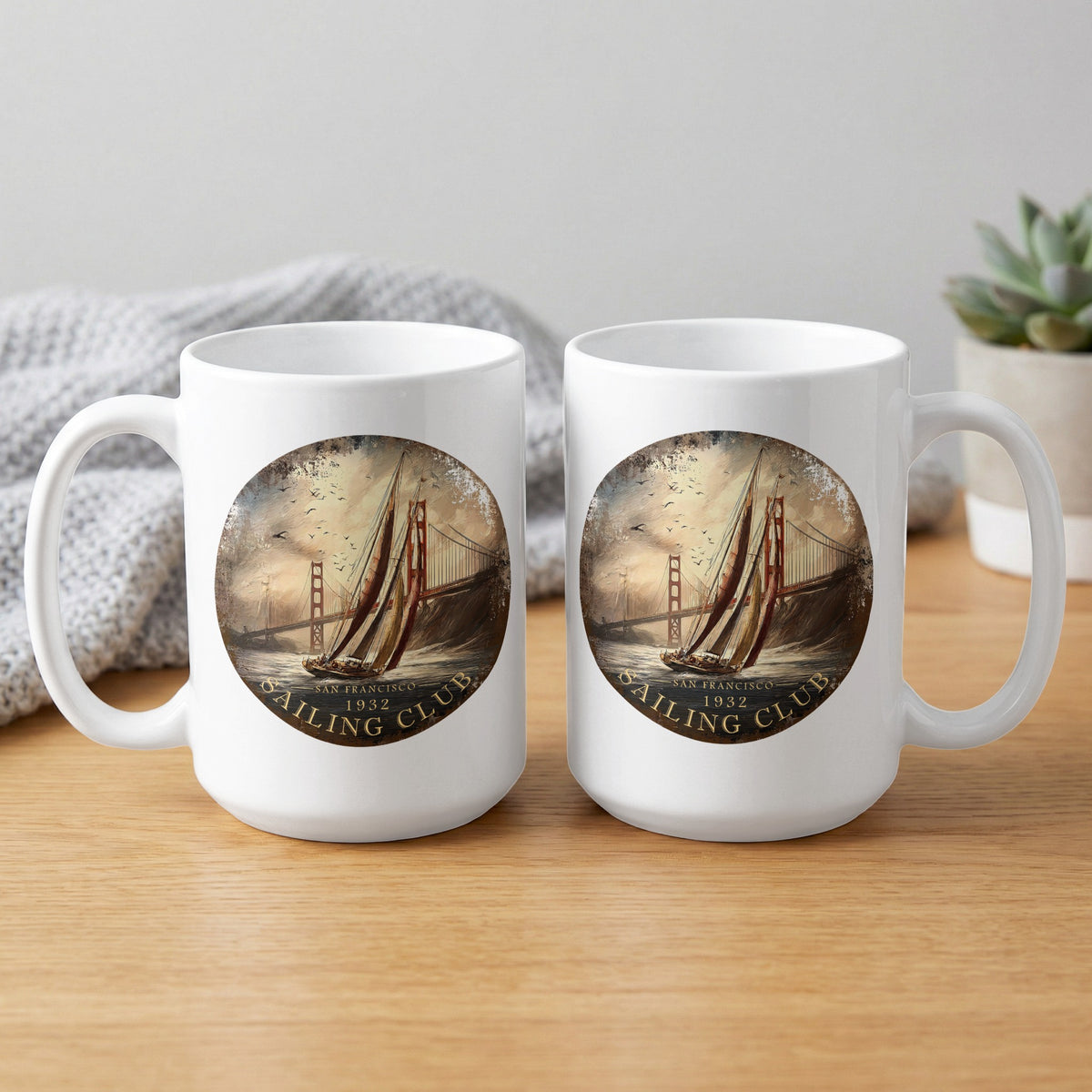 White 15oz mugs showing front and back with circular sailing artwork, Golden Gate Bridge and 'Sailing Club' lettering.