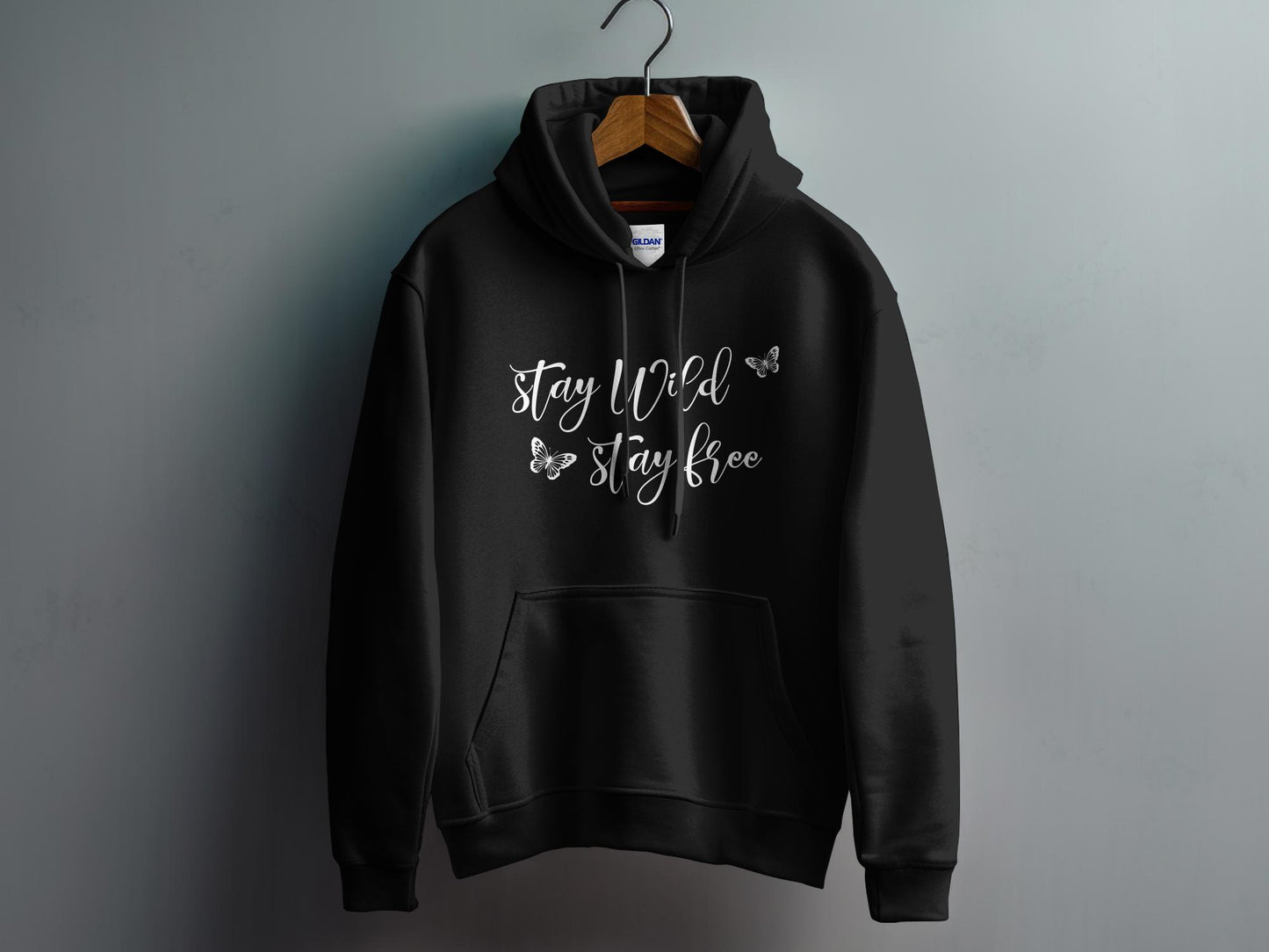 Black Stay Wild Stay Free Hoodie with a vibrant graphic, soft cotton blend, and unisex sizing for a comfortable fit.