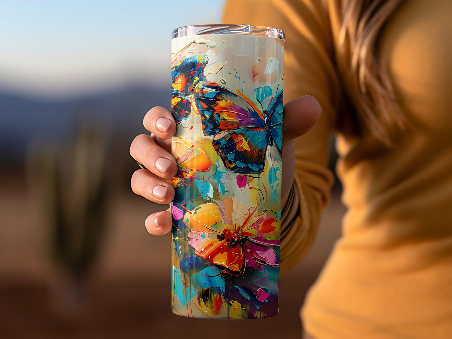 Watercolour butterflies tumbler in hand, 20oz stainless steel with vibrant watercolour butterfly graphics and secure lid