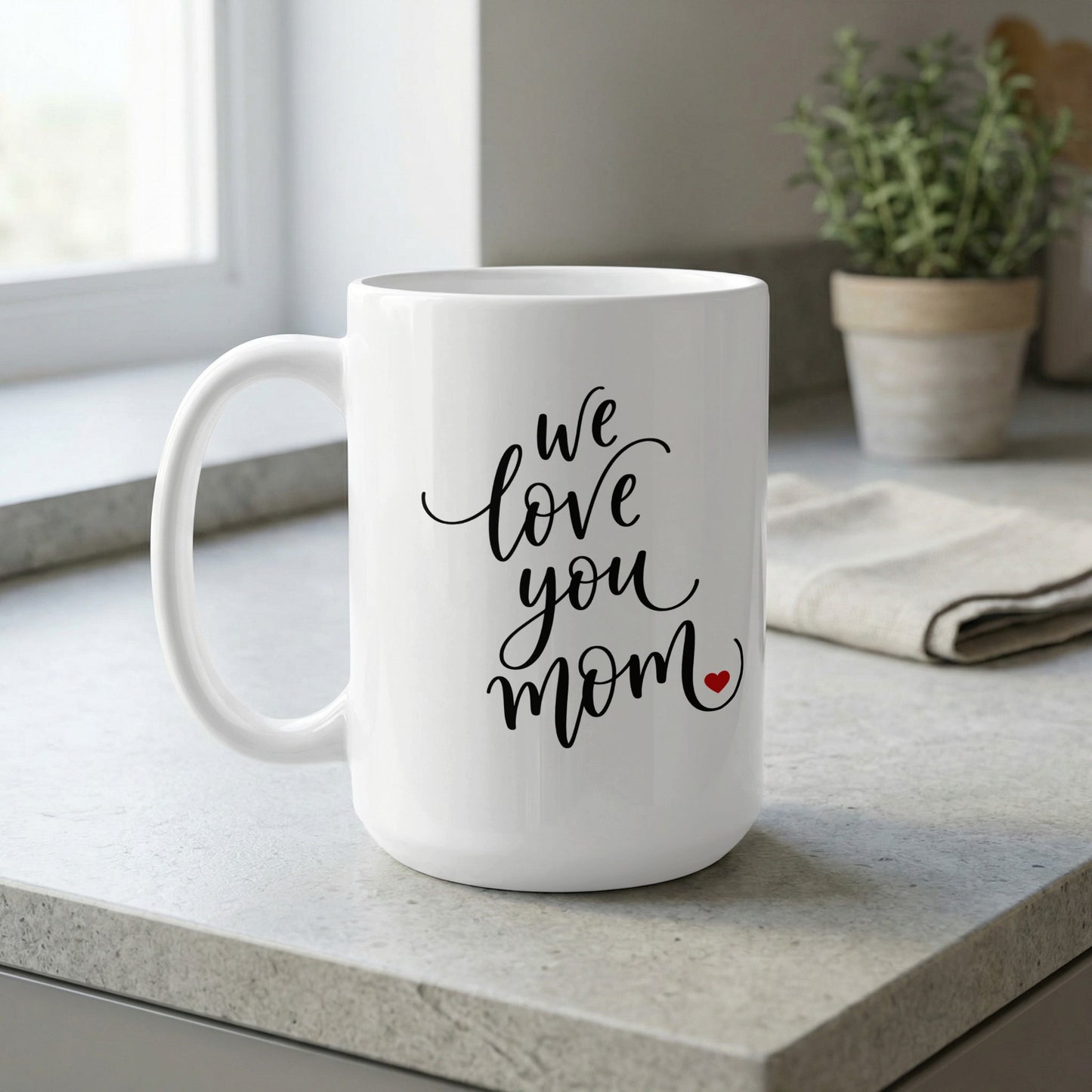 We Love You Mom 15oz ceramic mug by window, perfect for relaxing coffee moments and thoughtful gifting.
