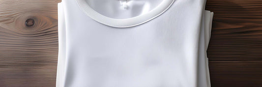 Folded white ribbed t-shirt on a dark timber surface showing fabric texture and neckline detail.