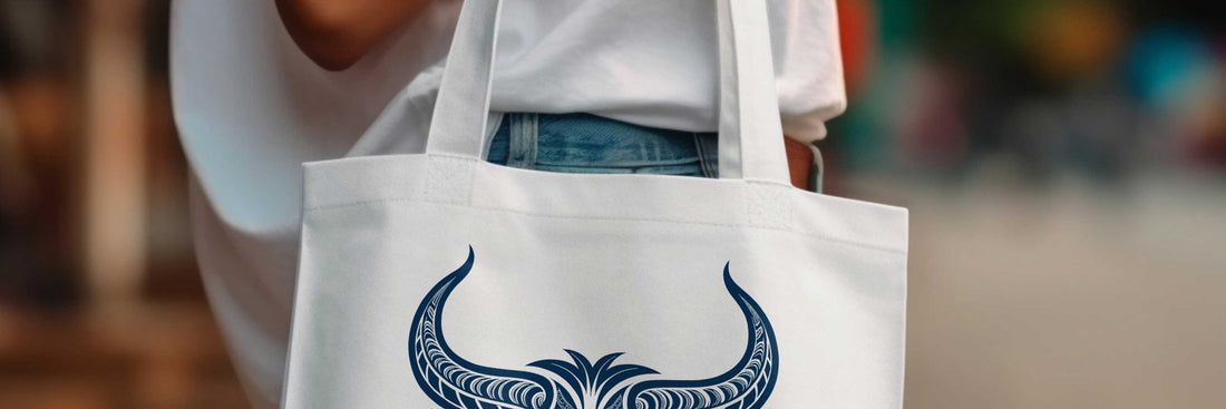 Woman carrying a white tote bag with zodiac-inspired graphic in a casual street setting.