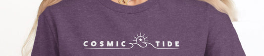 Woman wearing a heather purple crew-neck t-shirt with Cosmic Tide sun, wave and star chest graphic.