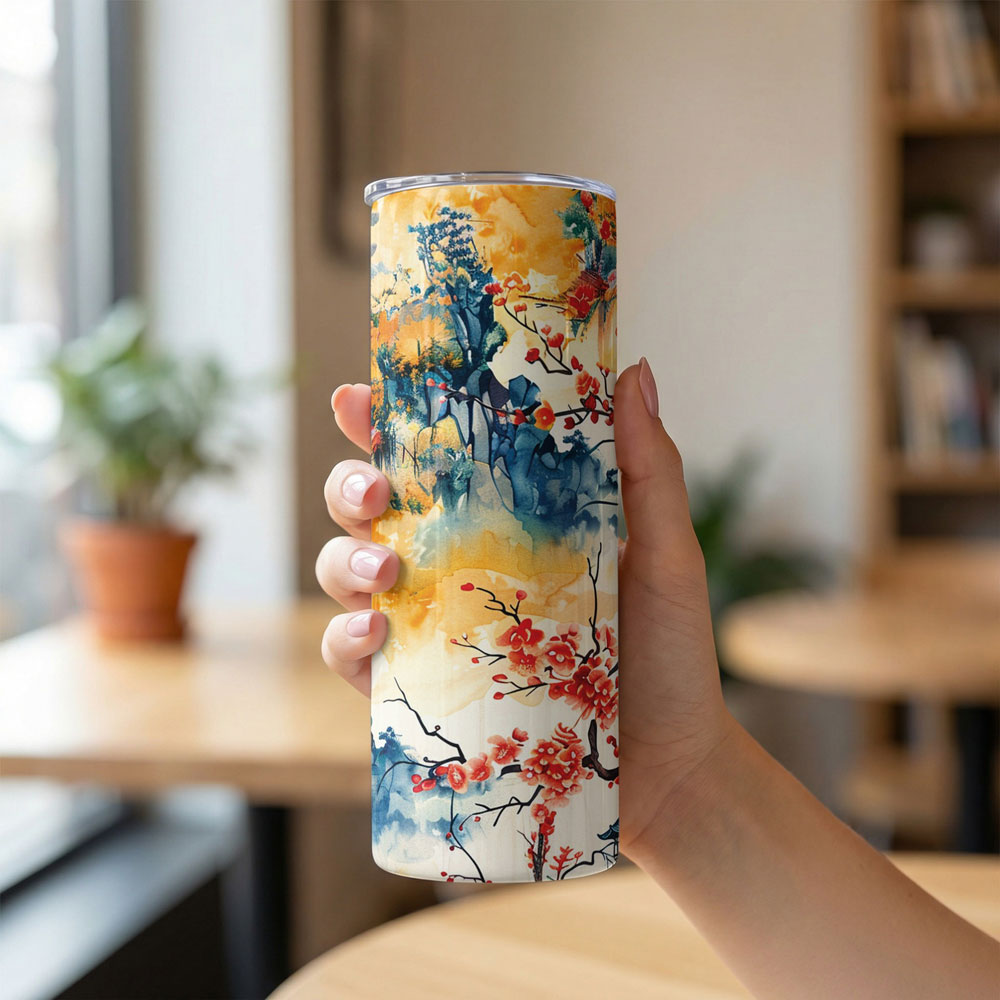 20oz insulated skinny tumbler with Japanese watercolour cherry blossom and plum branch print held in hand.