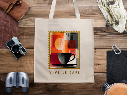 Abstract Coffee Blocks canvas tote bag with black cup and saucer, layered colour blocks, golden circle and gold serrated stamp border.