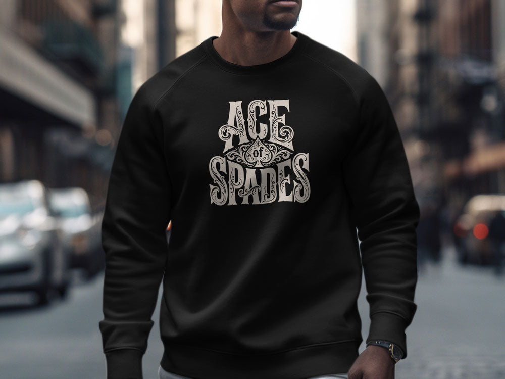 Man wearing black crew neck sweatshirt featuring ornate Ace of Spades typographic chest artwork with relaxed fit styling.