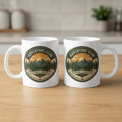 Two Adventure Club 11oz ceramic mugs displaying the Explore & Discover outdoor badge on both sides.