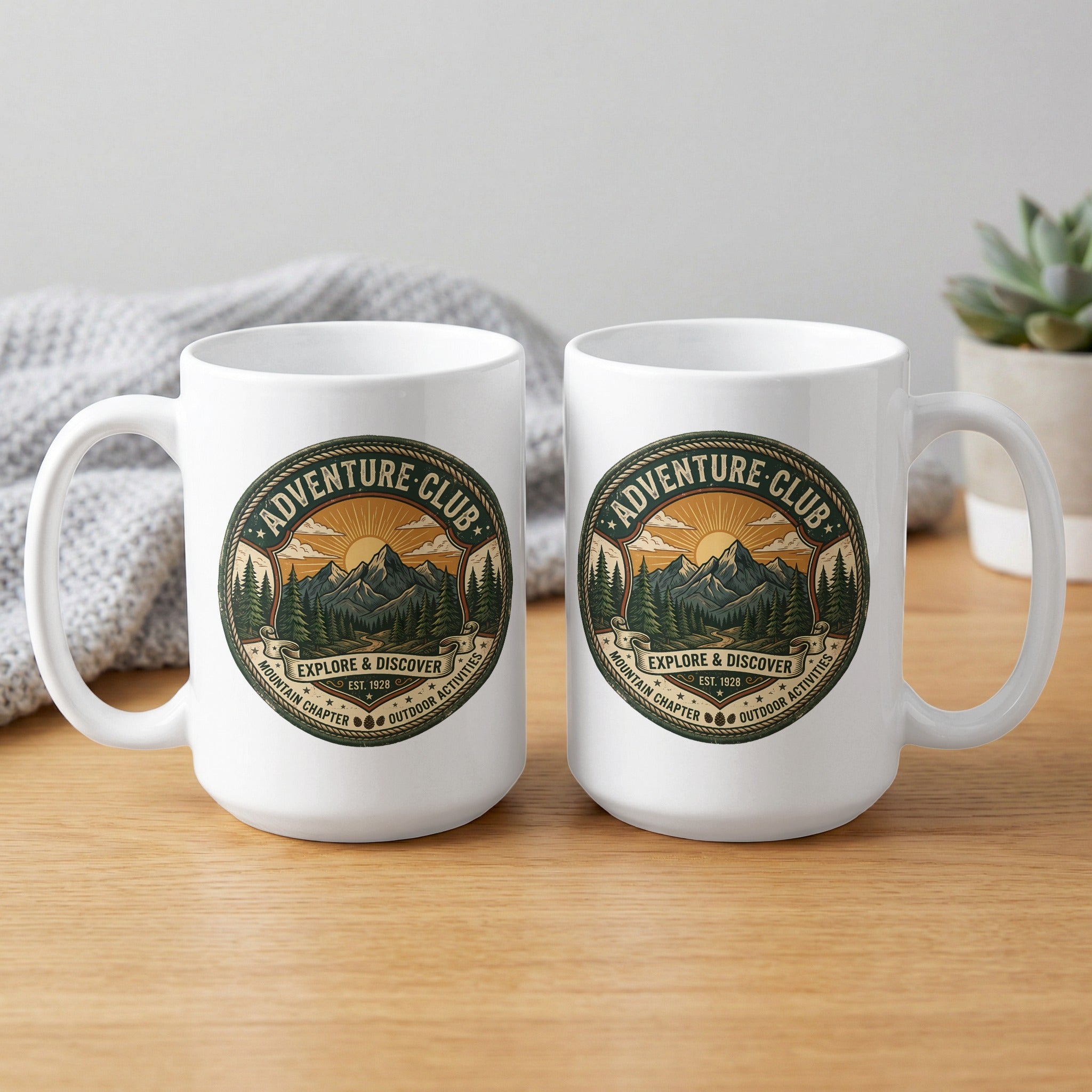 Two Adventure Club 15oz mugs showcasing rope-bordered mountain adventure artwork from both sides.