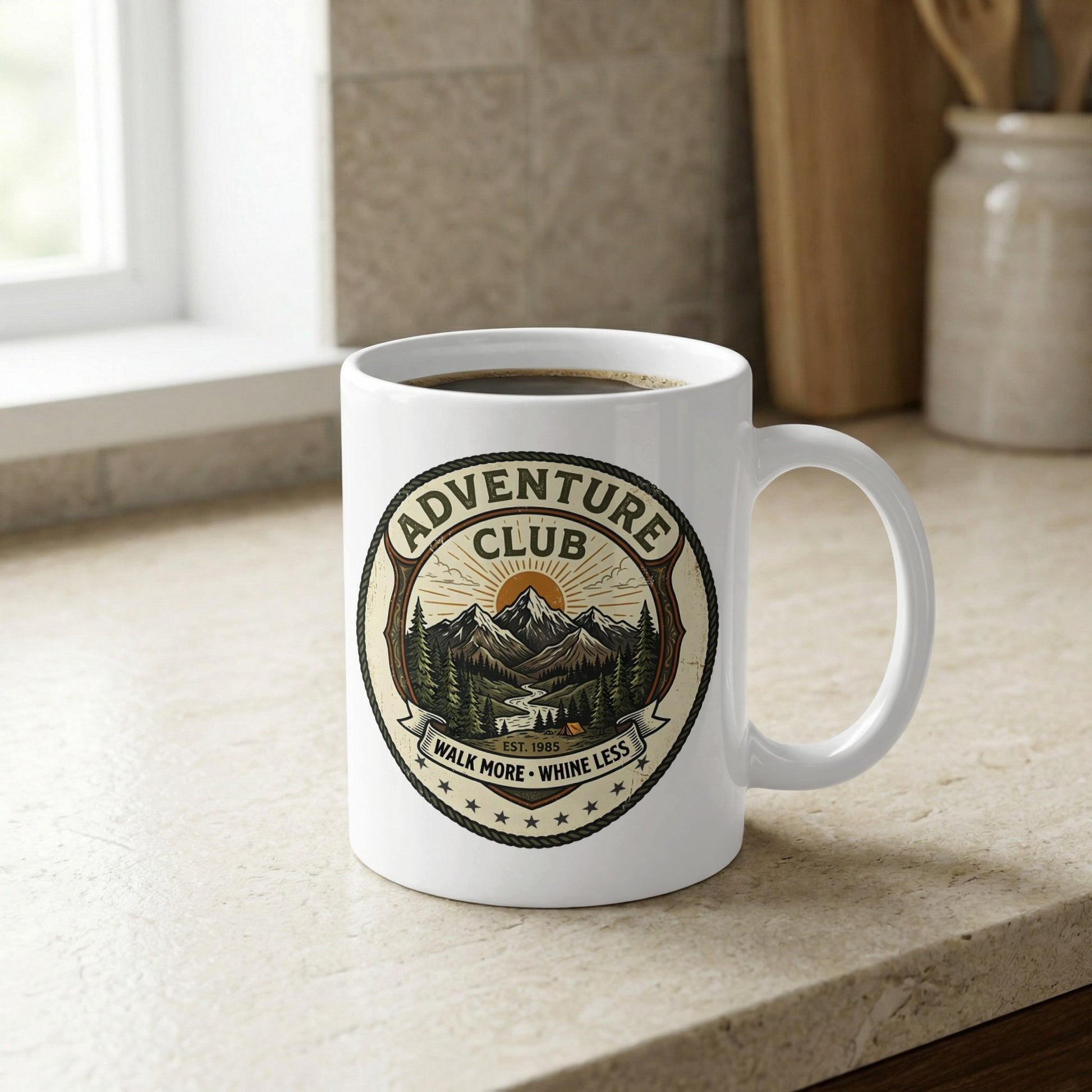 Detailed view of the 11oz glossy ceramic mug showing the olive green, amber, and rope-bordered hiking club patch.