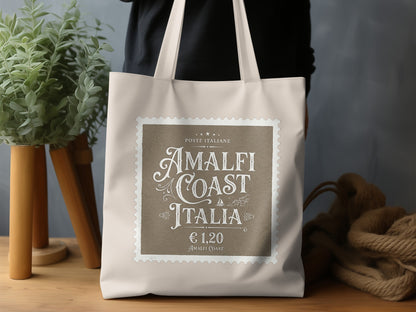Amalfi Coast Italia Tote Bag in a lifestyle setting, highlighting its refined Italian-inspired vintage typography and natural canvas.