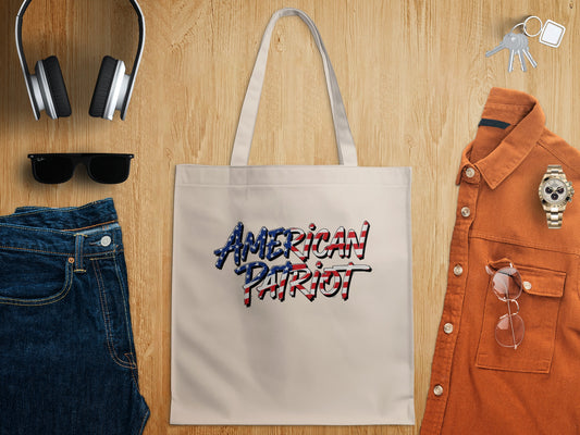 American Patriot Tote Bag in natural canvas featuring bold graffiti lettering filled with red, white and blue US flag details.