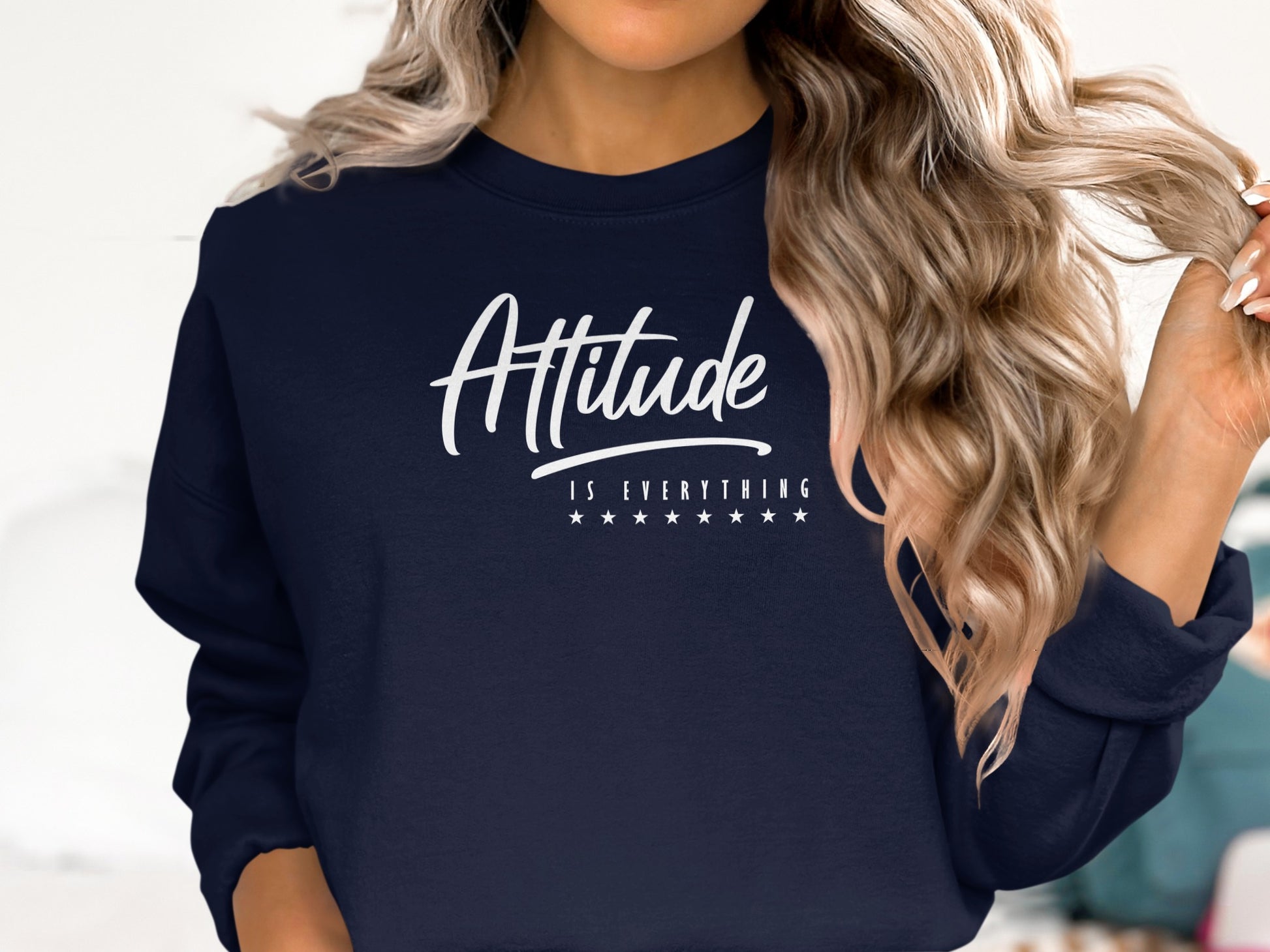 Navy blue motivational sweatshirt with Attitude is Everything message, relaxed unisex style and cozy cotton blend fabric.