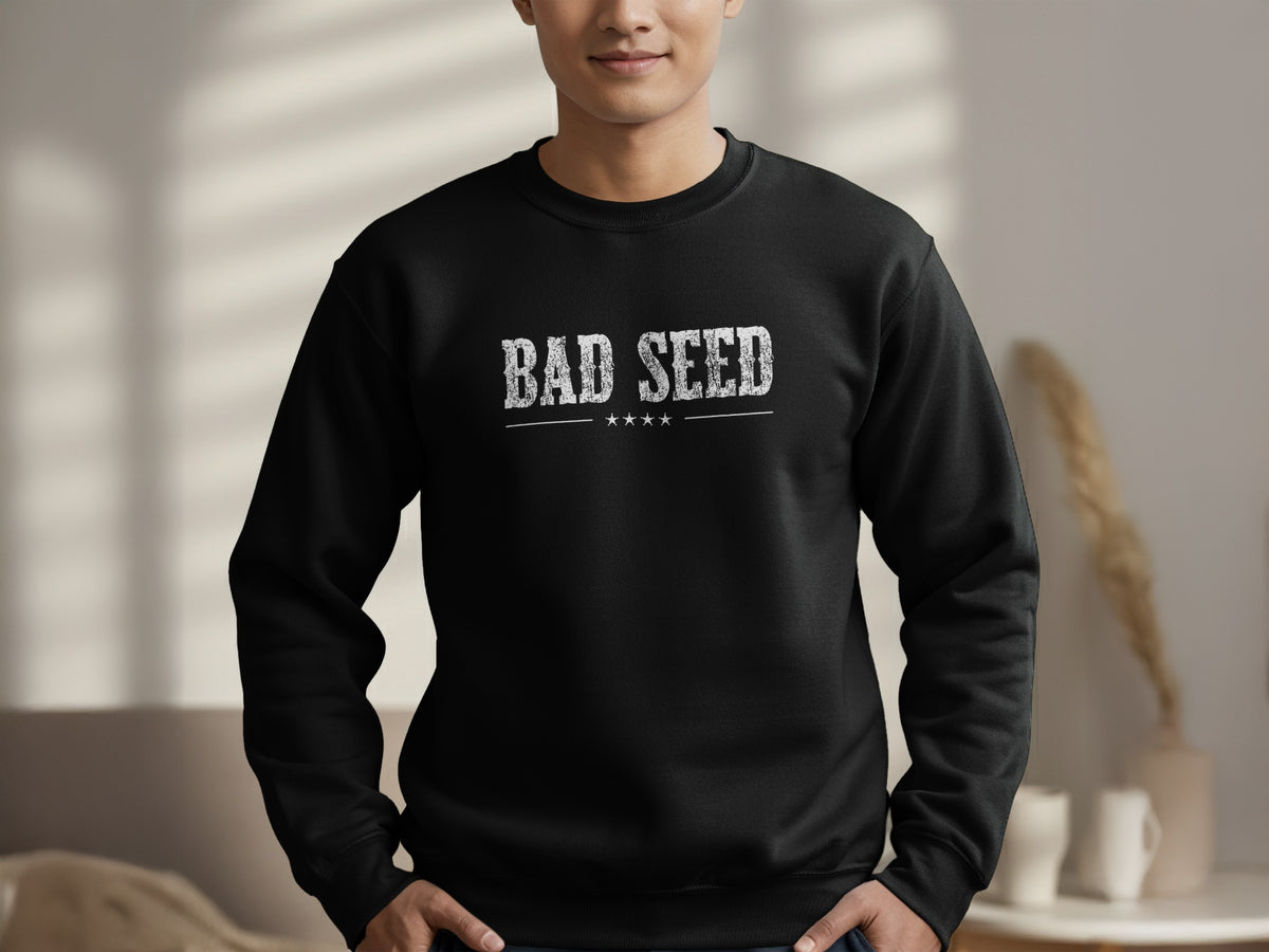 Black Bad Seed crewneck sweatshirt showing the bold BAD SEED statement, thin horizontal rule and four white star accents beneath.