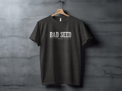 Dark Heather Grey Bad Seed T-Shirt with bold white distressed typography, four stars and a clean linear chest detail.