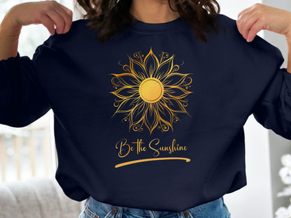 Navy pullover sweatshirt featuring Be the Sunshine slogan in bright print, relaxed casual crew neck cut for everyday wear.
