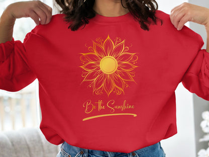 Bright red crewneck sweatshirt with uplifting Be the Sunshine inspirational message, unisex fit, and cotton-blend fabric.