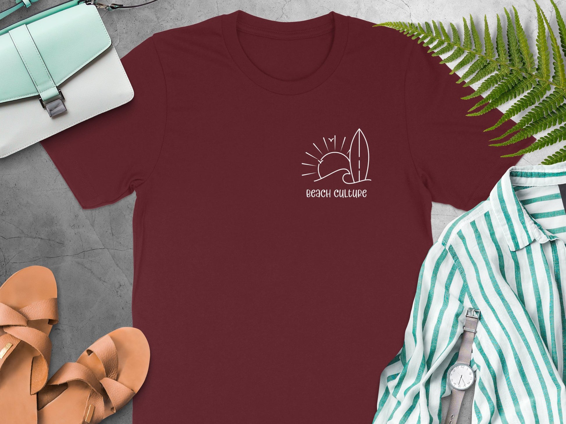 Maroon Beach Culture t-shirt with a small white left-chest graphic in a coastal line-art style.
