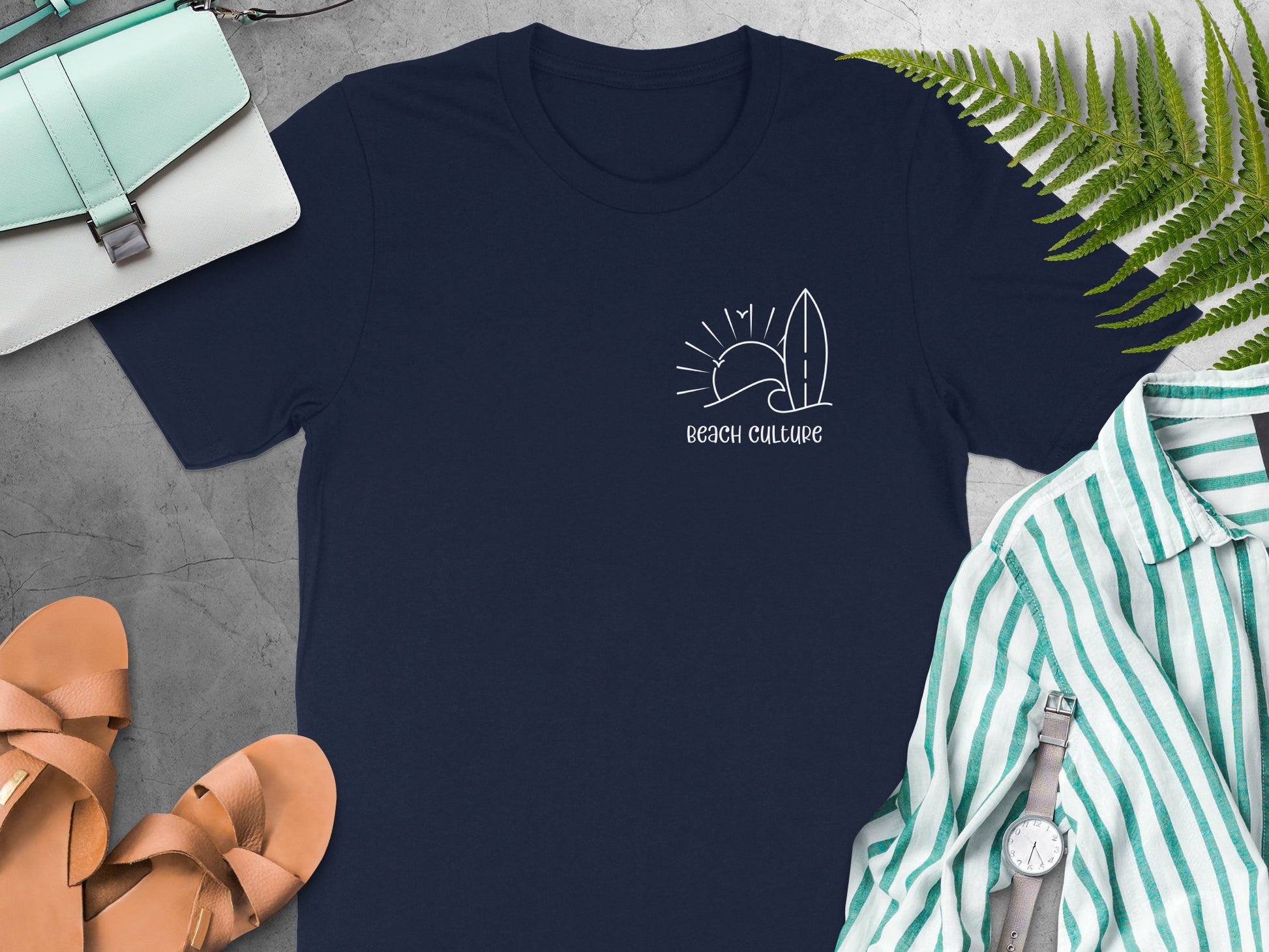 Navy blue Beach Culture t-shirt with a white line-drawing chest print of a wave, sun, birds, and surfboard.