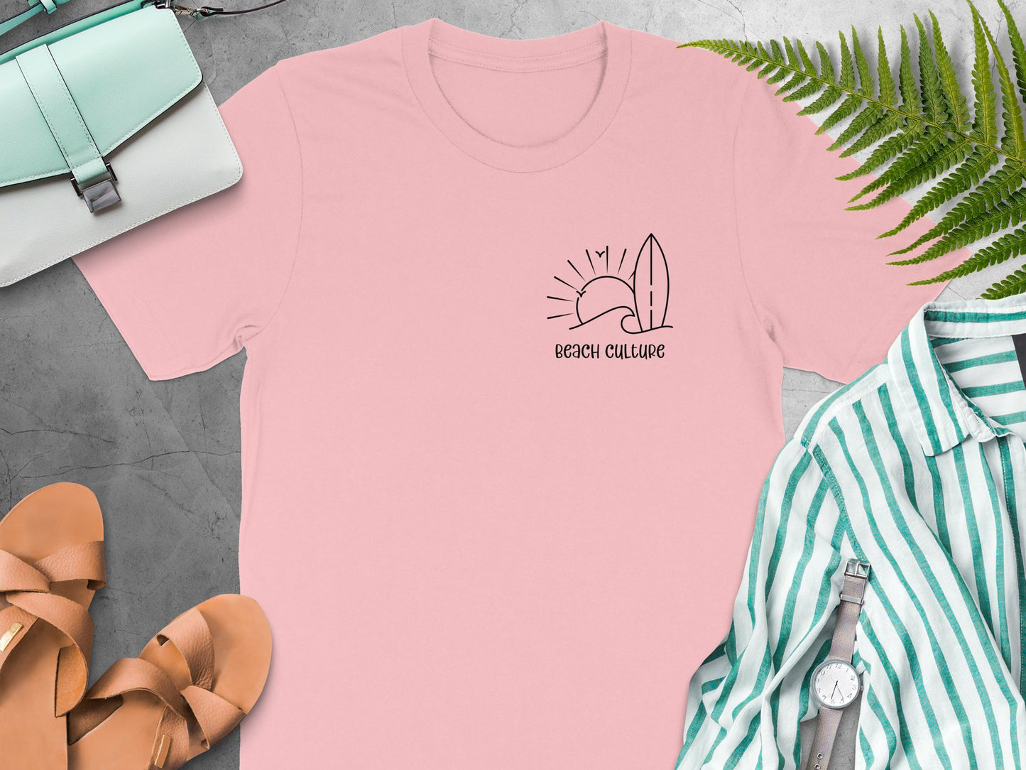 Pink Beach Culture t-shirt featuring a simple black left-chest line-art graphic of a wave, sun, surfboard, and birds.