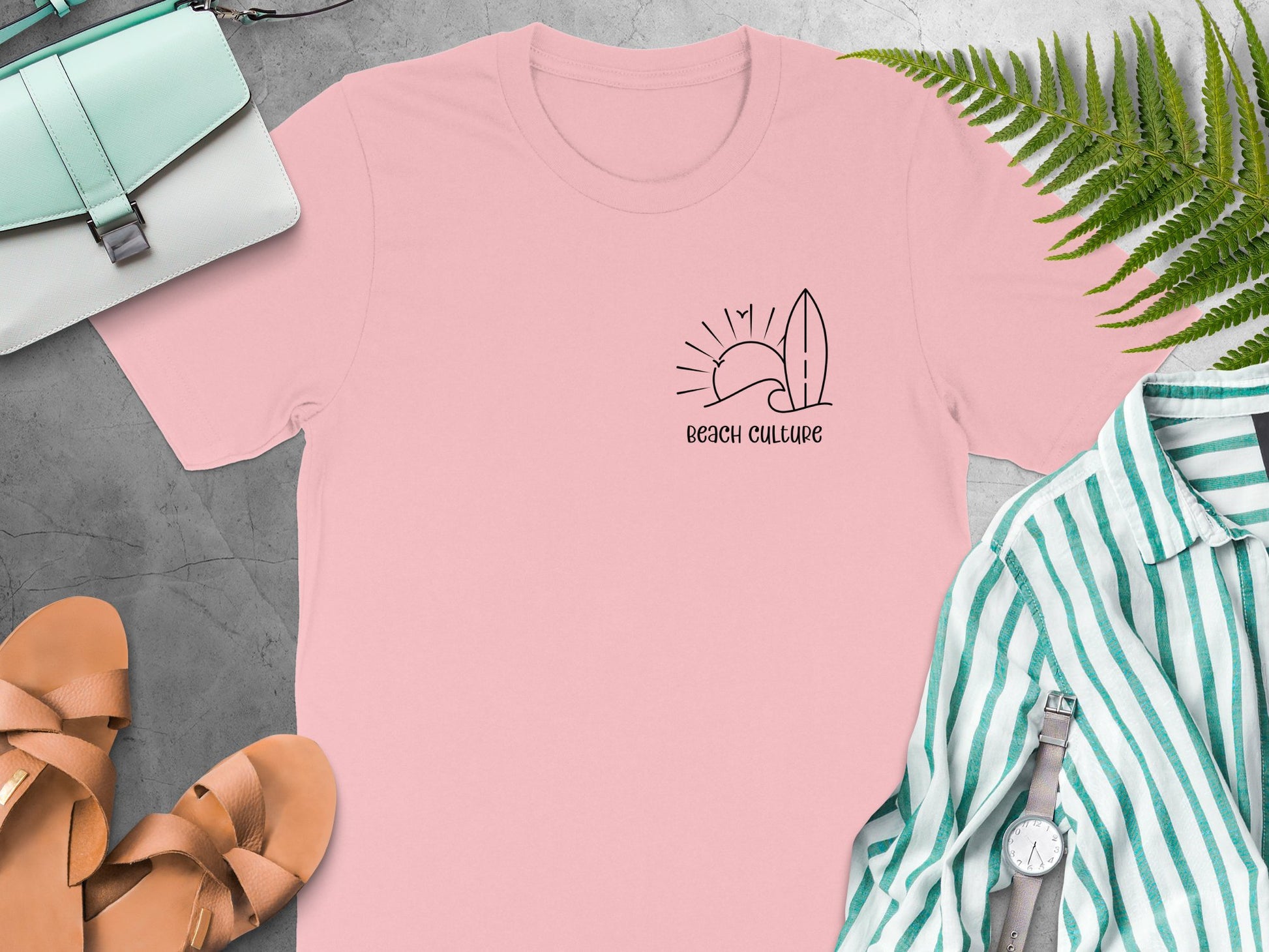Pink Beach Culture t-shirt featuring a simple black left-chest line-art graphic of a wave, sun, surfboard, and birds.