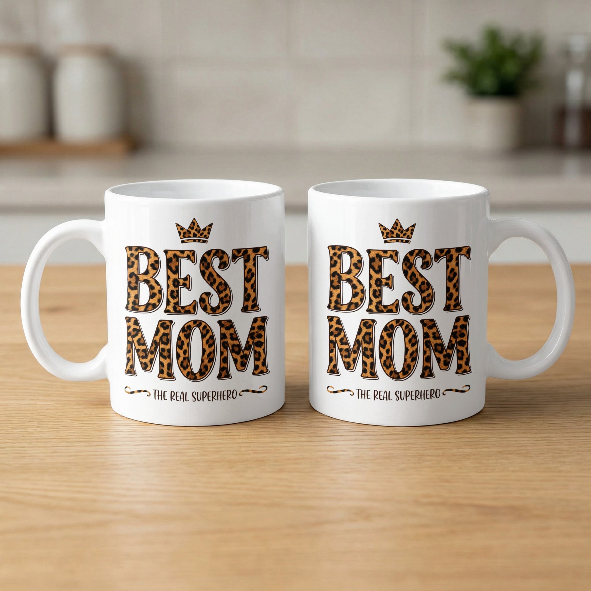 Two Best Mom The Real Superhero 11oz mugs showing both sides of bold leopard print design and glossy ceramic finish.
