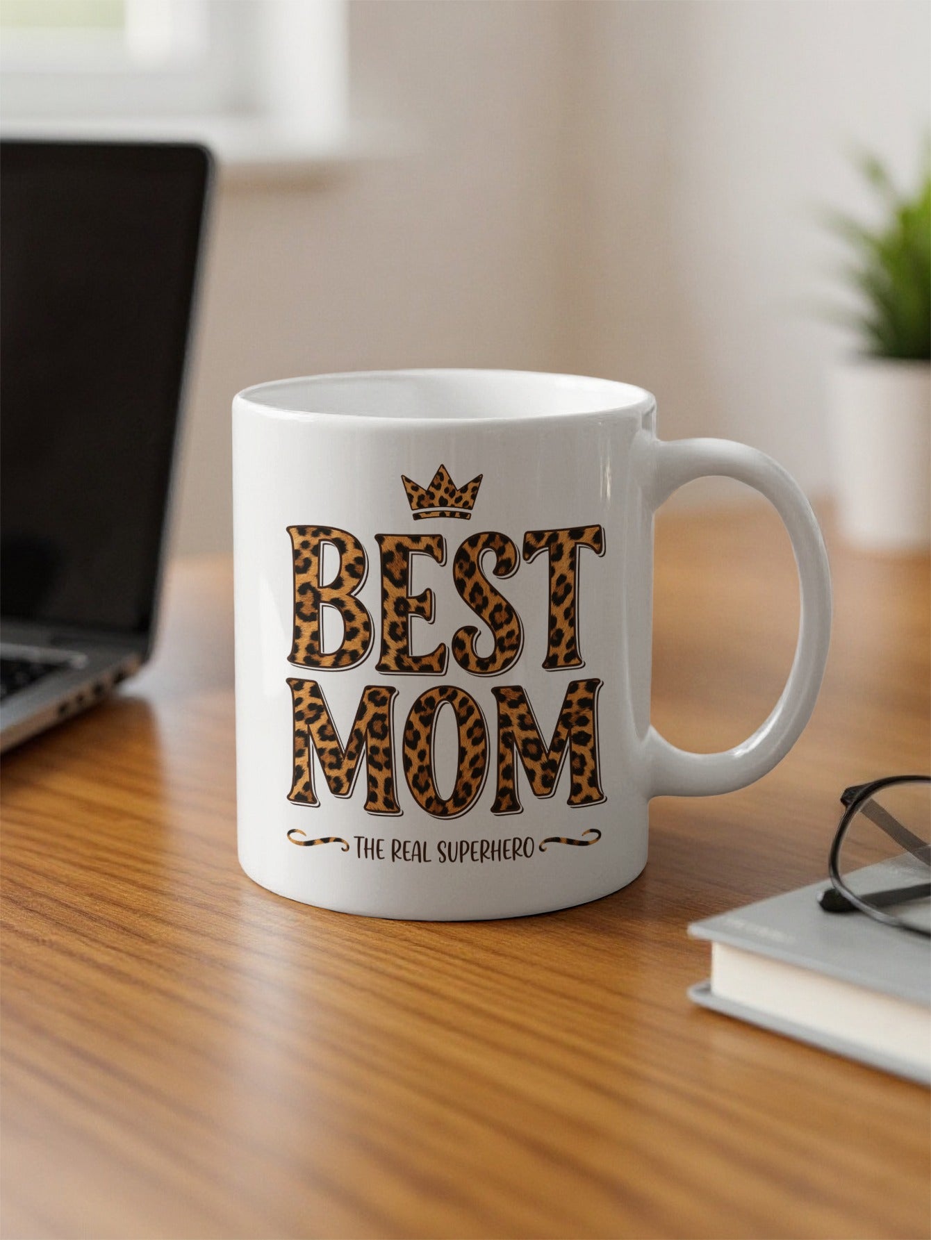 Best Mom The Real Superhero 11oz mug on office desk by computer, adding bold leopard style to daily coffee breaks.
