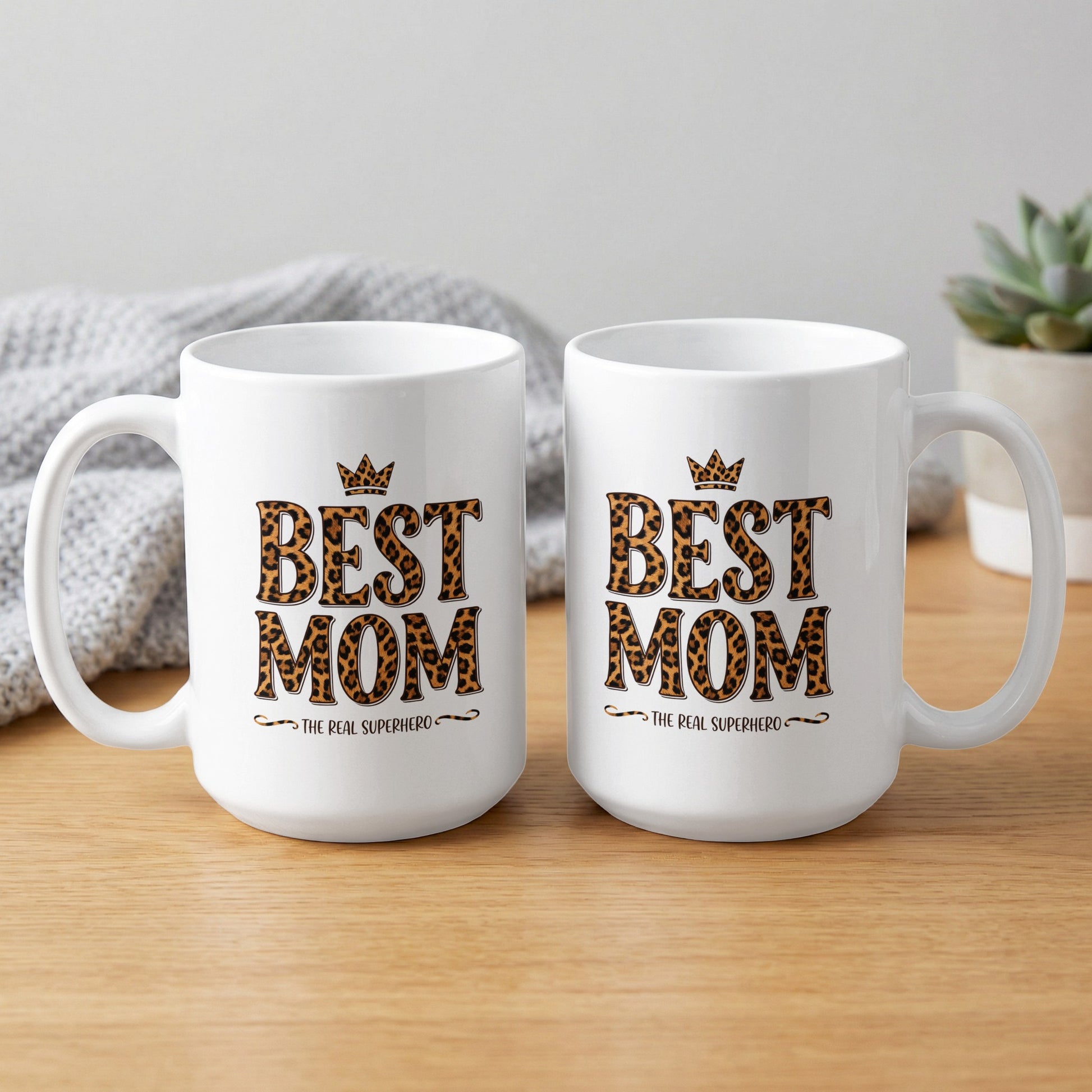 Two Best Mom The Real Superhero 15oz mugs showing full leopard print design, bold glossy ceramic finish for gifting.