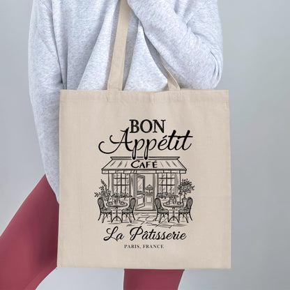 Bon Appétit graphic tote bag featuring monochrome French café illustration and vintage typography, a traditional storefront and fine architectural linework.