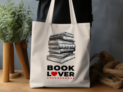 Book Lover Tote Bag lifestyle display with detailed book illustration, natural canvas, red heart and decorative red stars beneath.