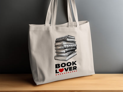 Book Lover Tote Bag on timber sideboard featuring bold black BOOK LOVER text with red heart and eleven red stars beneath.