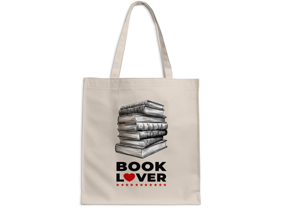 Book Lover cream canvas tote bag on white background with detailed stack of books, bold black lettering, red heart accent and small red stars.