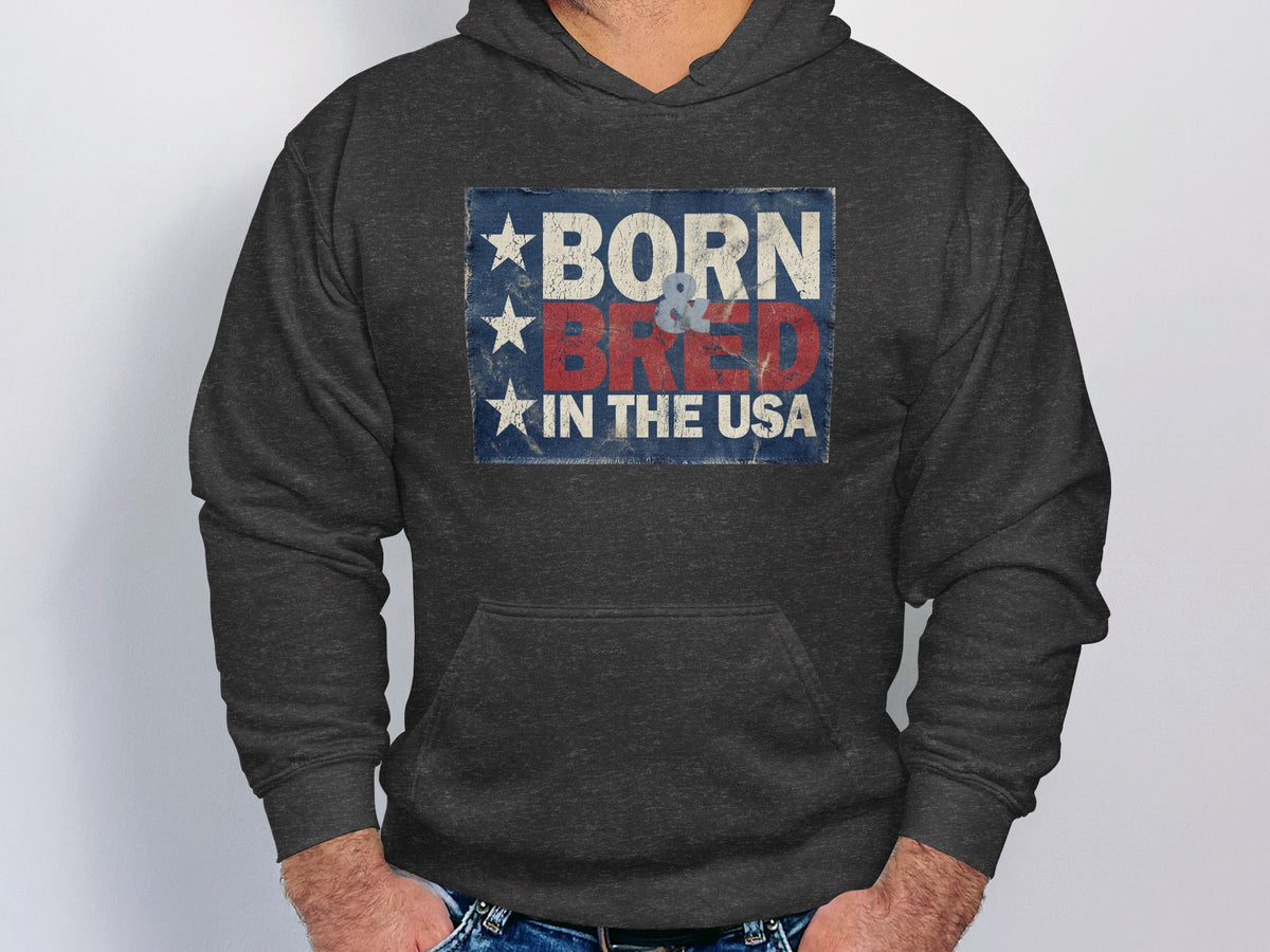 Charcoal Heather Born & Bred in the USA Hoodie displaying bold red and off-white lettering in a distressed vintage Americana design.