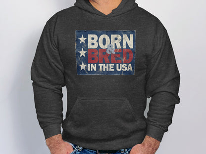 Charcoal Heather Born & Bred in the USA Hoodie displaying bold red and off-white lettering in a distressed vintage Americana design.