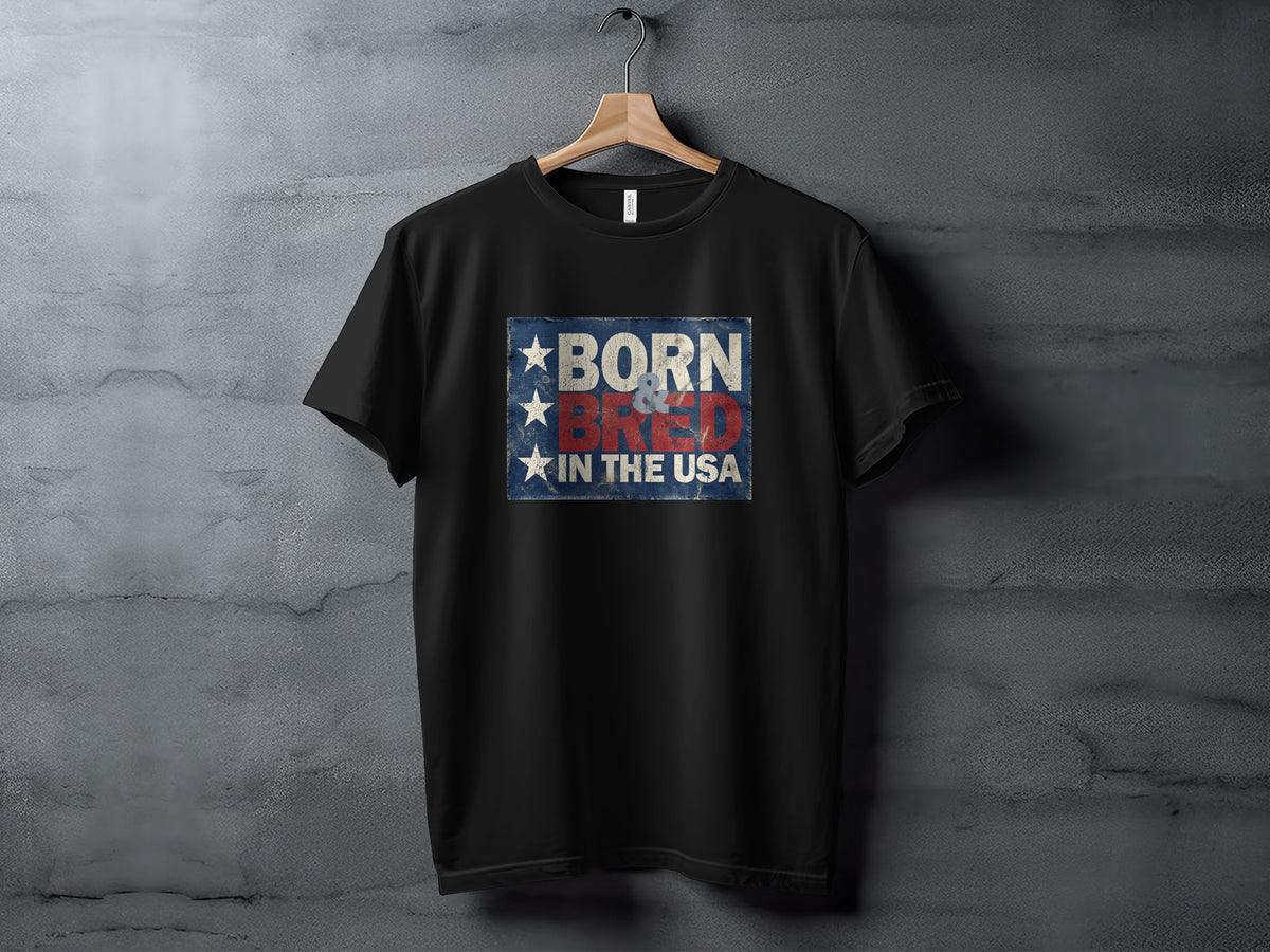 Hanging black Born & Bred in the USA T-Shirt showcasing stacked patriotic lettering, a weathered blue background and three white stars.