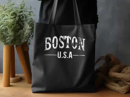 Boston Tote Bag displaying the full BOSTON U.S.A design with spaced serif lettering, horizontal rules and distressed white print on black canvas.
