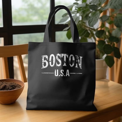Black Boston Tote Bag showing the worn, cracked texture across the bold white BOSTON lettering and heritage-style typography.