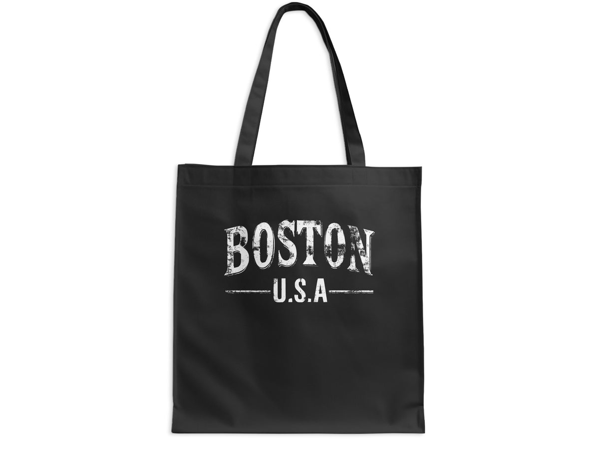 Boston tote bag featuring large distressed white BOSTON serif lettering and smaller U.S.A typography on black canvas.
