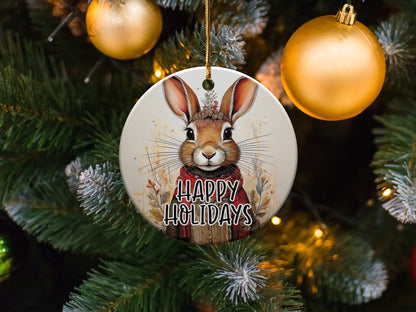 Ceramic Christmas ornament with detailed brown rabbit portrait, dried flower crown, and seasonal greeting.